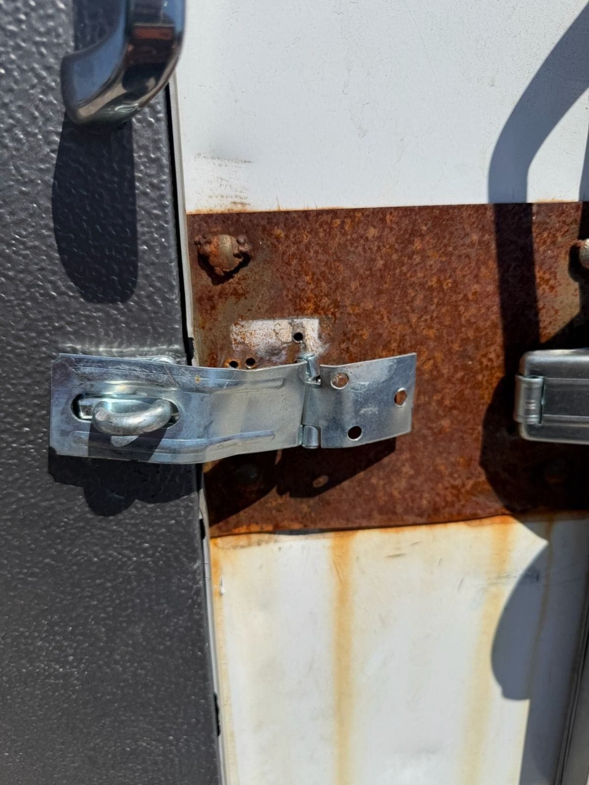 Bent and loose hasp on an ice merchandiser door