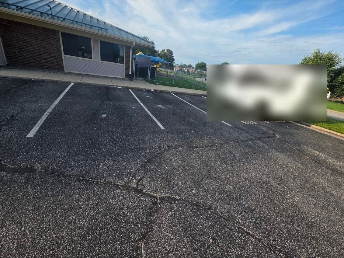 Parking stalls with faded, barely visible lines