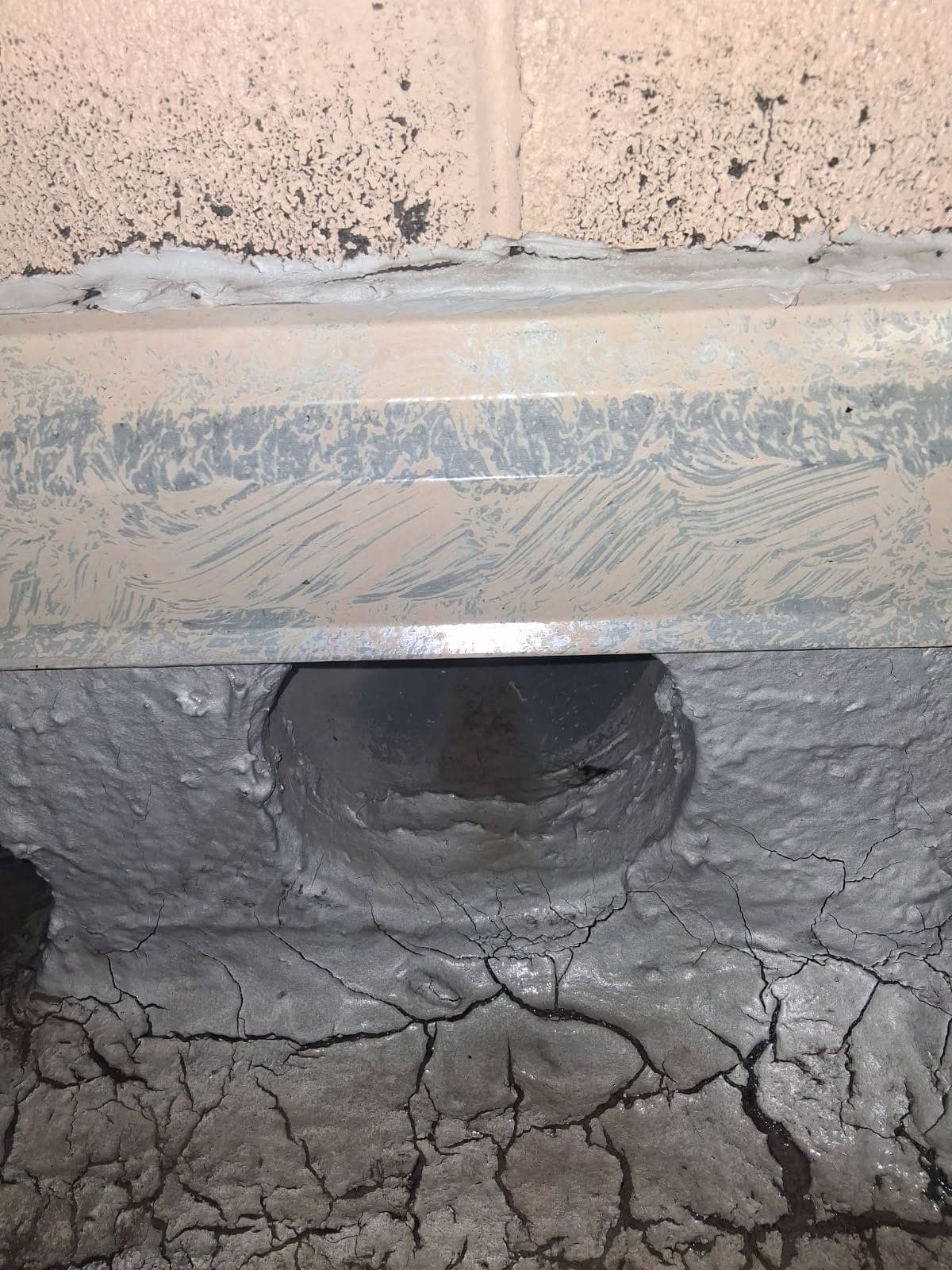 The same scupper opening after clearing, with the roof surface drained
