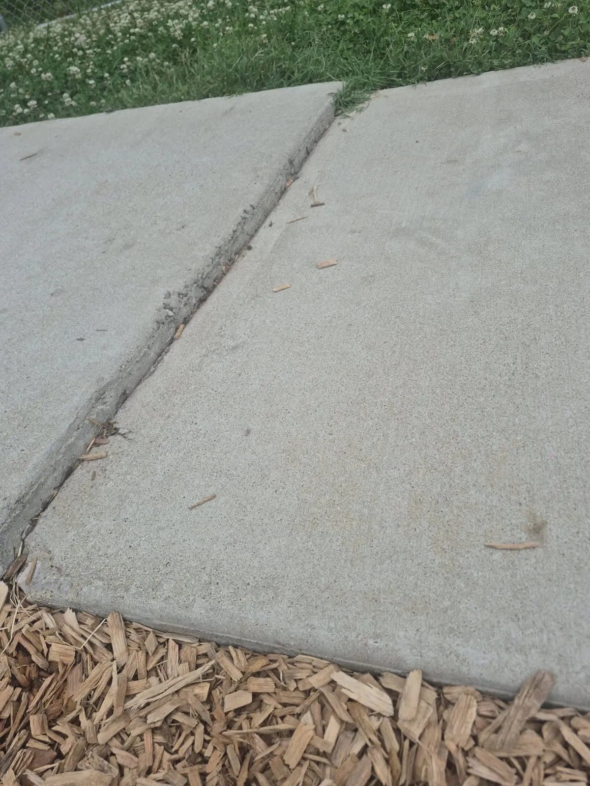 Sidewalk joint with one slab heaved above the other